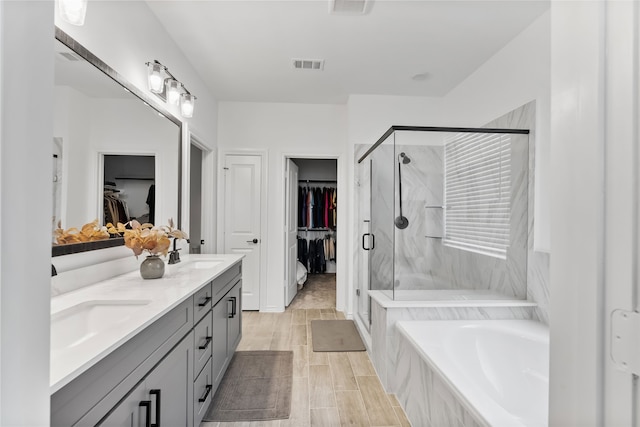 1224 Garden Jade Dr, Katy, TX 77493 - full bathroom with double vanity, a walk in closet, a garden tub, and a stall shower