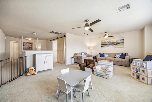 18314 Harvest Star Ct, Houston, TX 77084 - carpeted living area with a barn door and ceiling fan