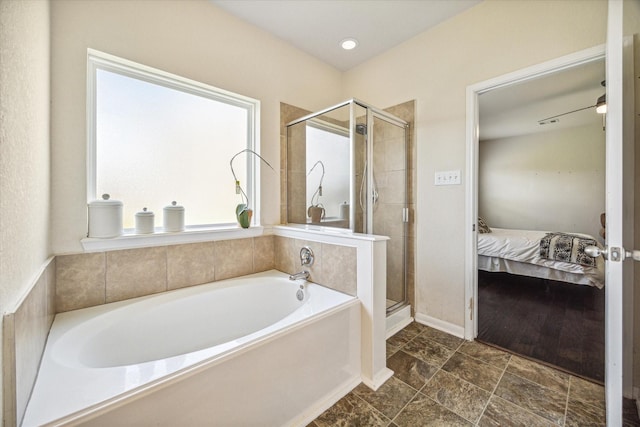 18314 Harvest Star Ct, Houston, TX 77084 - ensuite bathroom featuring a garden tub, plenty of natural light, and a shower stall