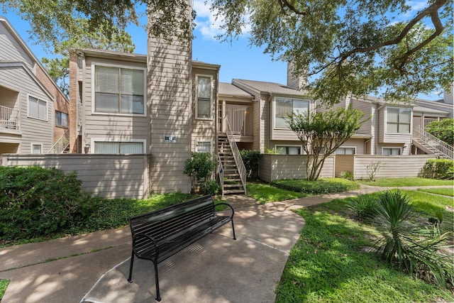 6701 Sands Point Dr Unit 114, Houston, TX 77074 - view of front of house with stairway and a chimney