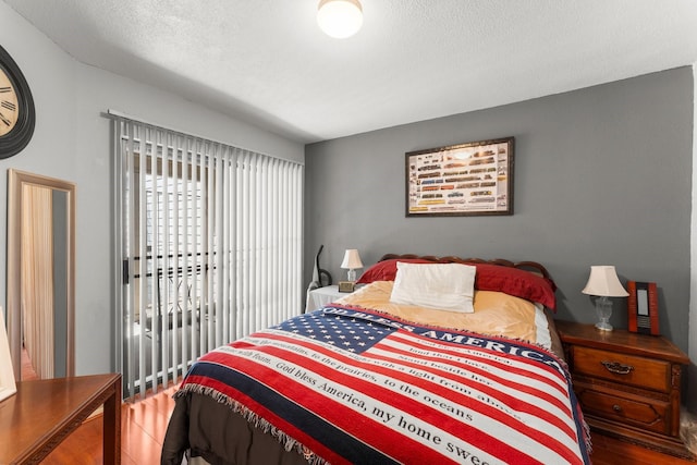 6701 Sands Point Dr Unit 114, Houston, TX 77074 - bedroom with wood finished floors and a textured ceiling