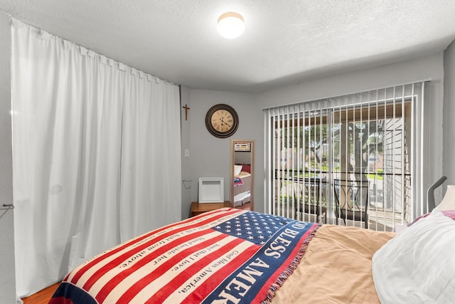 6701 Sands Point Dr Unit 114, Houston, TX 77074 - bedroom with a textured ceiling and access to outside