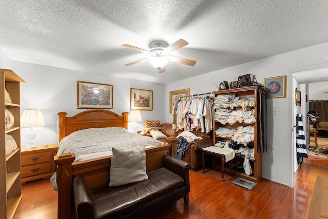 6701 Sands Point Dr Unit 114, Houston, TX 77074 - bedroom with wood finished floors, a textured ceiling, and ceiling fan