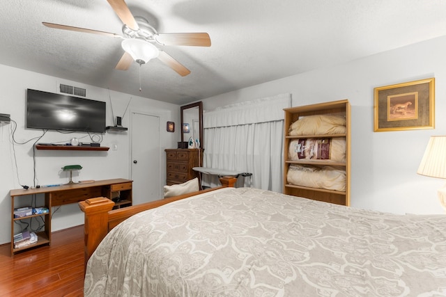 6701 Sands Point Dr Unit 114, Houston, TX 77074 - bedroom with wood finished floors, ceiling fan, and a textured ceiling
