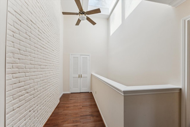 4932 Post Oak Timber Dr, Houston, TX 77056 - hall featuring a high ceiling, dark wood-style flooring, and a skylight