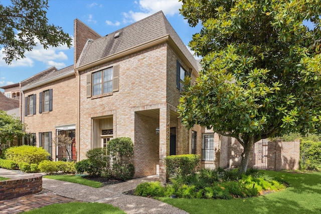 4932 Post Oak Timber Dr, Houston, TX 77056 - view of side of home featuring brick siding, a lawn, and roof with shingles