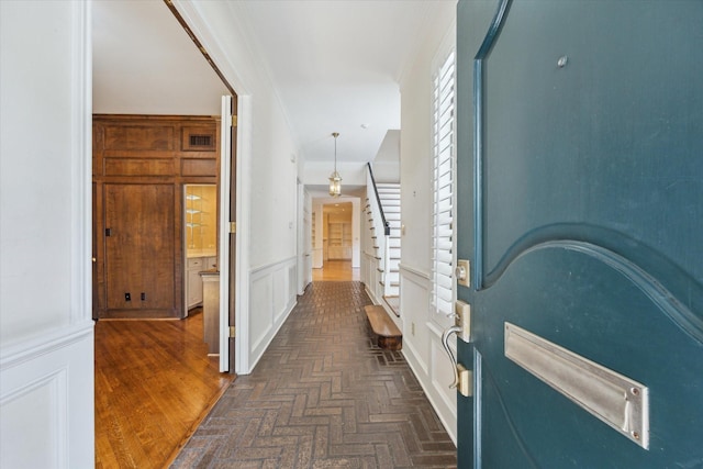 4932 Post Oak Timber Dr, Houston, TX 77056 - hall featuring crown molding, a decorative wall, and wainscoting