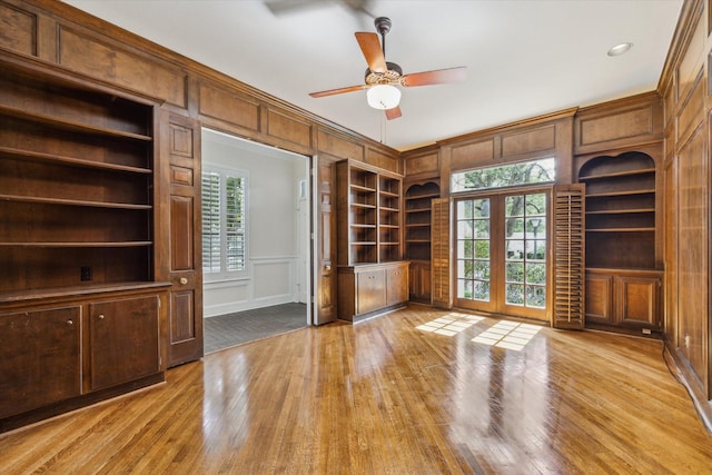 4932 Post Oak Timber Dr, Houston, TX 77056 - interior space with a decorative wall, wood-type flooring, french doors, ceiling fan, and crown molding