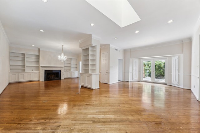 4932 Post Oak Timber Dr, Houston, TX 77056 - unfurnished living room with light wood finished floors, built in shelves, a chandelier, a fireplace, and ornamental molding