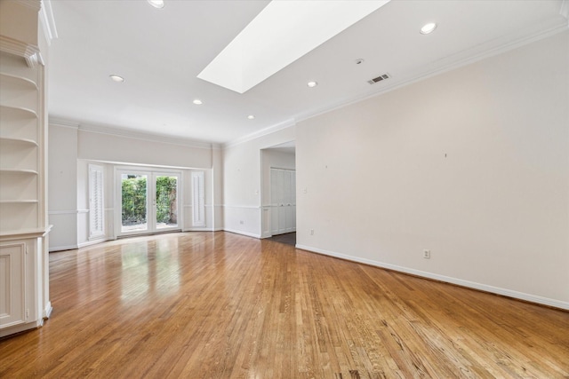 4932 Post Oak Timber Dr, Houston, TX 77056 - spare room featuring crown molding, a skylight, light wood-type flooring, and recessed lighting