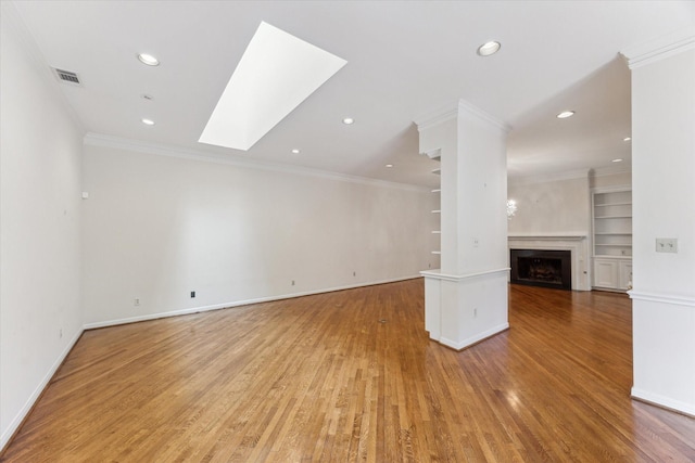 4932 Post Oak Timber Dr, Houston, TX 77056 - unfurnished living room with ornamental molding, light wood-type flooring, a skylight, a fireplace, and recessed lighting