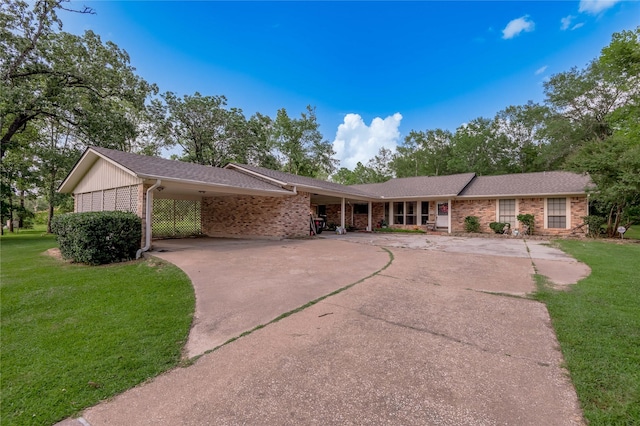 459 Brookwood Dr, Diboll, TX 75941 - ranch-style home featuring concrete driveway, brick siding, a front lawn, and an attached carport