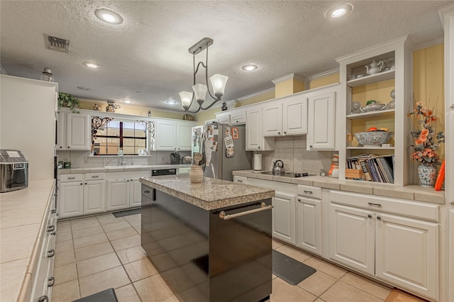 459 Brookwood Dr, Diboll, TX 75941 - kitchen featuring freestanding refrigerator, open shelves, white cabinets, decorative backsplash, and a textured ceiling