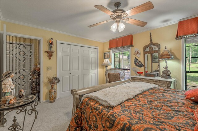 459 Brookwood Dr, Diboll, TX 75941 - bedroom featuring carpet flooring, ornamental molding, a ceiling fan, and a closet