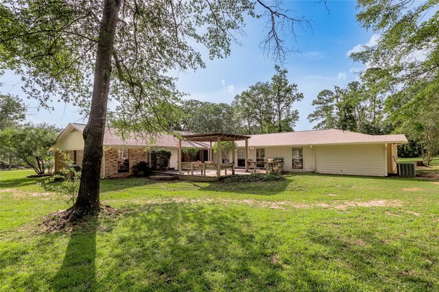 459 Brookwood Dr, Diboll, TX 75941 - back of house featuring a pergola and a lawn