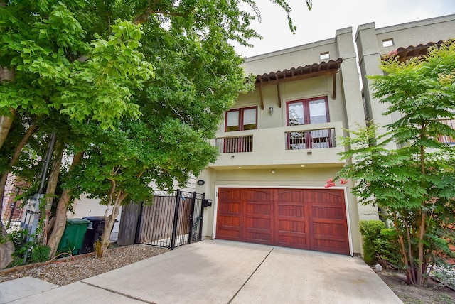 5238 Nett St, Houston, TX 77007 - townhome / multi-family property with an attached garage, concrete driveway, stucco siding, and a balcony