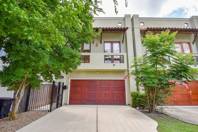 5238 Nett St, Houston, TX 77007 - view of front of house with driveway, stucco siding, a garage, a balcony, and french doors