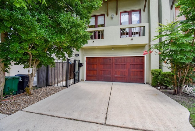 5238 Nett St, Houston, TX 77007 - view of property featuring stucco siding, a balcony, and a garage