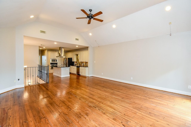 5238 Nett St, Houston, TX 77007 - unfurnished living room featuring vaulted ceiling, ceiling fan, light wood-style flooring, and recessed lighting