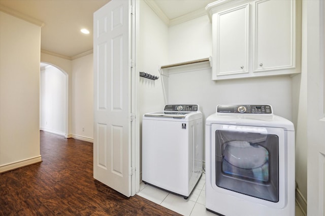 1518 Dunlavy St, Houston, TX 77006 - laundry area with cabinet space, washer and dryer, ornamental molding, arched walkways, and wood finished floors