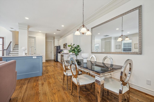 1518 Dunlavy St, Houston, TX 77006 - dining area featuring ornamental molding, wood finished floors, recessed lighting, stairway, and healthy amount of natural light