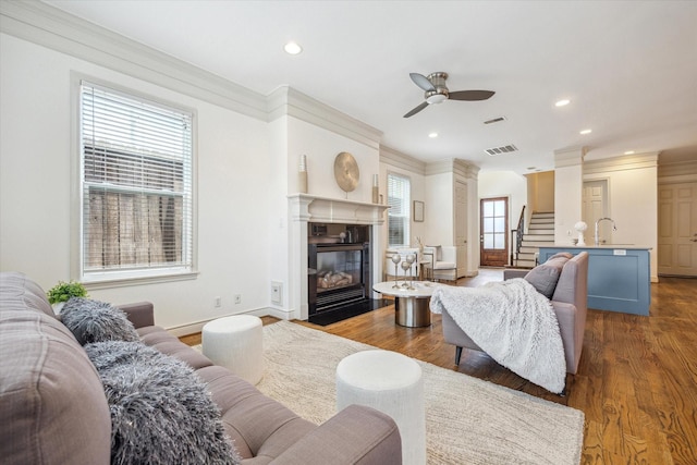 1518 Dunlavy St, Houston, TX 77006 - living area with stairs, ceiling fan, wood finished floors, a fireplace with flush hearth, and ornamental molding