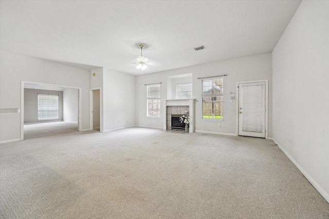 2016 Fairwood St, Pearland, TX 77581 - unfurnished living room with carpet flooring, ceiling fan, and a tiled fireplace