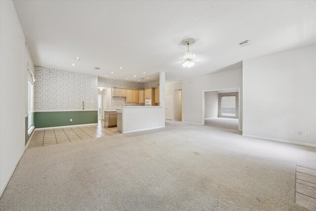 2016 Fairwood St, Pearland, TX 77581 - unfurnished living room featuring light colored carpet, ceiling fan, wallpapered walls, light tile patterned floors, and recessed lighting