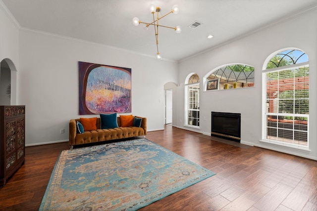 6531 Glenhill Dr, Spring, TX 77389 - living room with arched walkways, a chandelier, ornamental molding, wood finished floors, and a fireplace