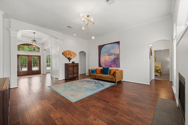 6531 Glenhill Dr, Spring, TX 77389 - living area featuring arched walkways, wood finished floors, french doors, ornamental molding, and a chandelier