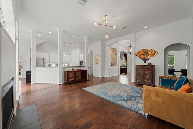 6531 Glenhill Dr, Spring, TX 77389 - living area featuring arched walkways, dark wood-type flooring, ornate columns, recessed lighting, and ornamental molding