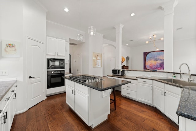 6531 Glenhill Dr, Spring, TX 77389 - kitchen featuring black appliances, arched walkways, ornamental molding, a kitchen bar, and white cabinetry