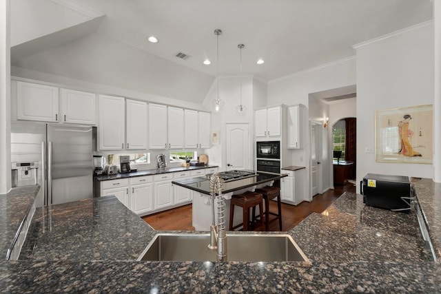 6531 Glenhill Dr, Spring, TX 77389 - kitchen featuring black appliances, arched walkways, ornamental molding, white cabinets, and hanging light fixtures