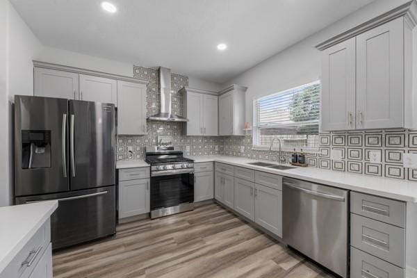 19602 Hardwood Ridge Trl, Cypress, TX 77429 - kitchen with wall chimney exhaust hood, stainless steel appliances, light countertops, recessed lighting, and tasteful backsplash