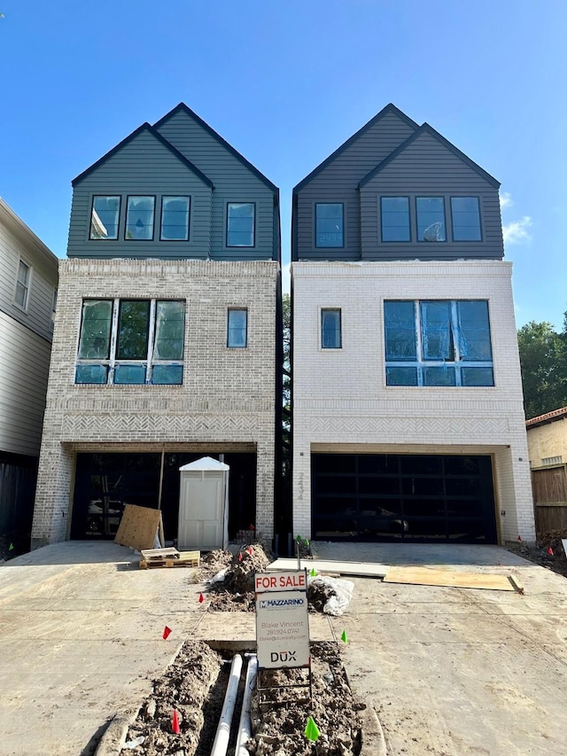 2434 Quenby St, Houston, TX 77005 - view of front of property featuring concrete driveway, an attached garage, and brick siding