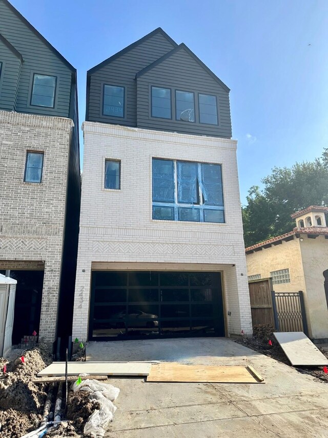 2434 Quenby St, Houston, TX 77005 - view of front of house with brick siding, driveway, and an attached garage