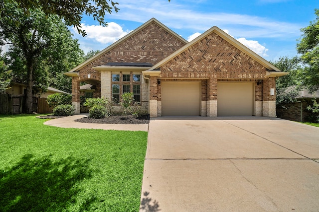 12311 Hawthorne Dr, Montgomery, TX 77356 - view of front of home with brick siding, concrete driveway, a garage, and stone siding