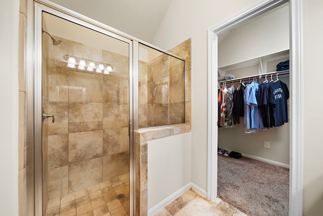12311 Hawthorne Dr, Montgomery, TX 77356 - bathroom featuring a stall shower, a spacious closet, and vaulted ceiling