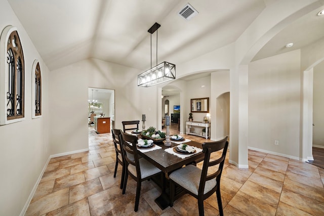 12311 Hawthorne Dr, Montgomery, TX 77356 - dining room featuring lofted ceiling, arched walkways, and light stone finish flooring