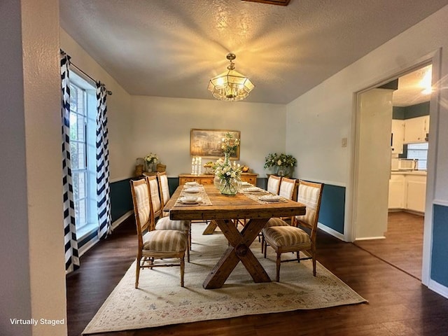 1215 Briar Ln, Wharton, TX 77488 - dining space featuring a chandelier, dark wood-type flooring, and a textured ceiling
