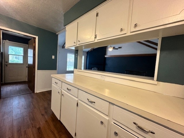 1215 Briar Ln, Wharton, TX 77488 - kitchen featuring a textured ceiling, dark wood-type flooring, white cabinets, plenty of natural light, and light countertops