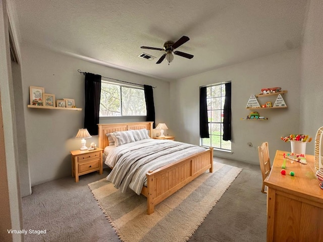 1215 Briar Ln, Wharton, TX 77488 - bedroom with multiple windows, light colored carpet, a textured ceiling, and ceiling fan