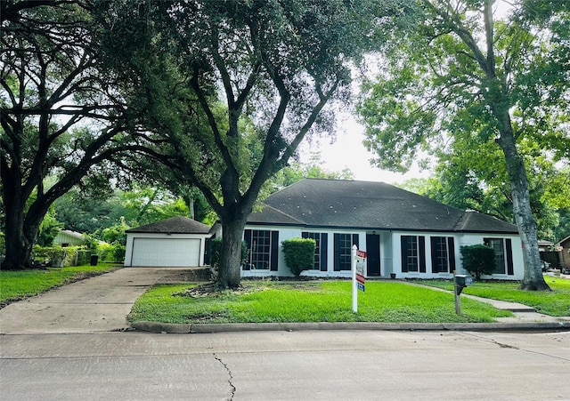 1215 Briar Ln, Wharton, TX 77488 - ranch-style home with concrete driveway, a front lawn, and a garage