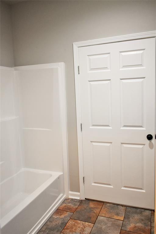 815 Leonard Ave, Richmond, TX 77469 - bathroom with stone finish floors and tub / shower combination