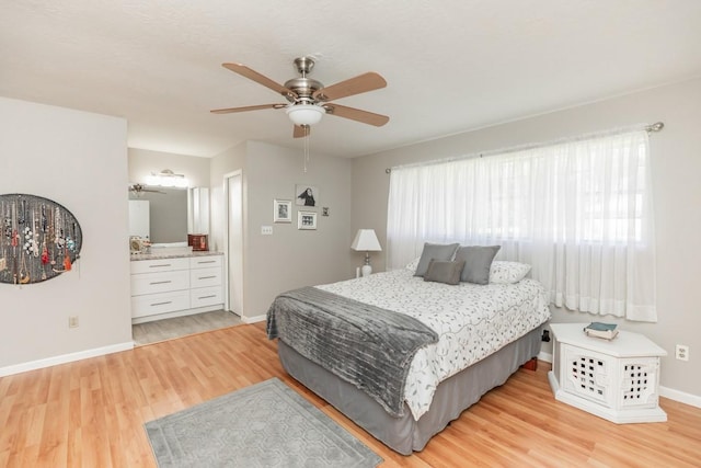 804 Camphor Cir, Village Mills, TX 77663 - bedroom with light wood-style floors, ceiling fan, and connected bathroom