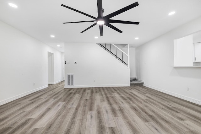 9602 Ballin David Dr, Spring, TX 77379 - unfurnished living room featuring recessed lighting, light wood-style floors, ceiling fan, and stairway