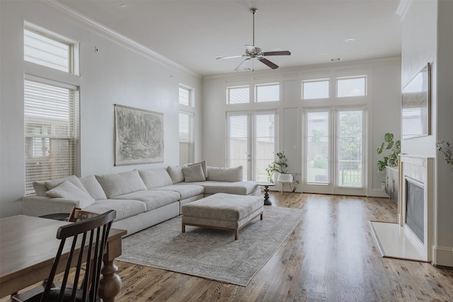 1207 W 25th St, Houston, TX 77008 - living area with ceiling fan, a fireplace with flush hearth, crown molding, and wood finished floors