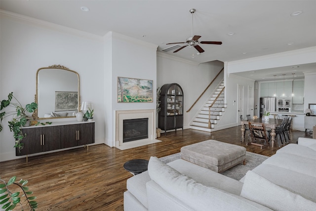 1207 W 25th St, Houston, TX 77008 - living room with crown molding, stairs, wood finished floors, a ceiling fan, and a fireplace with flush hearth