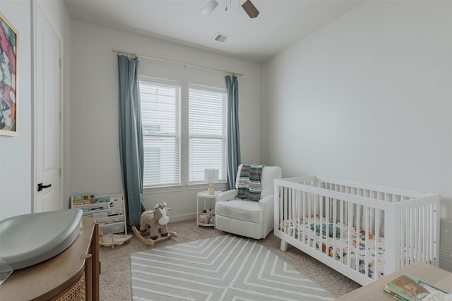 1207 W 25th St, Houston, TX 77008 - carpeted bedroom featuring a nursery area and a ceiling fan