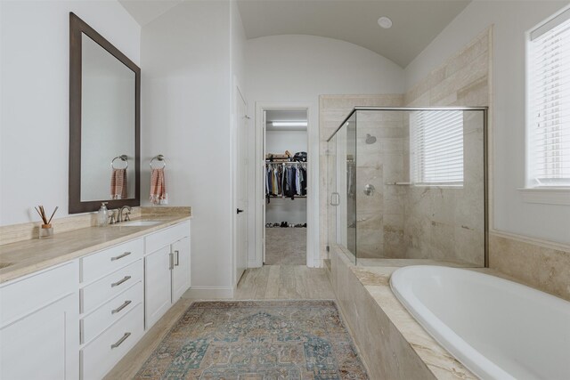 1207 W 25th St, Houston, TX 77008 - full bath with vanity, a garden tub, a stall shower, a walk in closet, and lofted ceiling